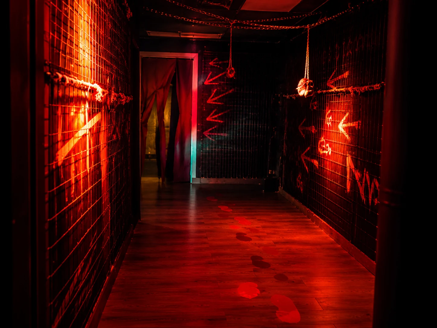 ZOE corridor with red lighting, hanging chains and marked walls